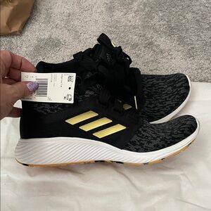 Adidas Black Sneakers with Gold Stripes